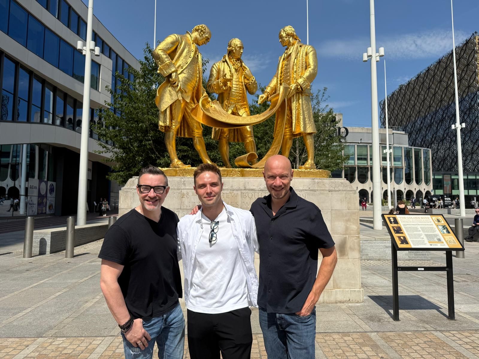 Co-Founders of Lunar Group - Rob Bloxham and Ed James - standing with Head of AI and Digital Transformation -Vlad Mukhachev - in front of the Lunar Men statue in Centenary Square, Birmingham.